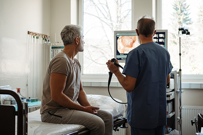 Doctor explains colorectal screening results to a patient.